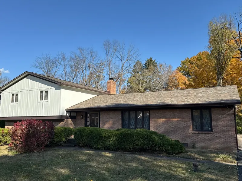 Brick ranch home with a new multi-tone shingle roof installed in the fall