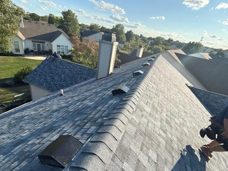 View down a new gray architectural shingle roof from the ridge
